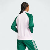 Adidas Adicolor Classics Loose Superstar Track Jacket Women's in clear pink, back view showcasing the oversized design lines and classic three stripes on the sleeves.